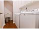 Laundry room with washer, dryer, and a utility sink on hardwood floors at 3082 Monarch Pine Dr, Peachtree Corners, GA 30071