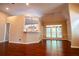 Bright living room featuring hardwood floors, a breakfast bar, and natural light streaming through large windows at 3082 Monarch Pine Dr, Peachtree Corners, GA 30071