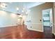 Spacious living room with dark hardwood floors, light-colored walls, and modern lighting fixtures at 3082 Monarch Pine Dr, Peachtree Corners, GA 30071