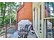 Charming balcony with seating overlooking lush greenery and the surrounding landscape at 4476 Paces Battle Nw, Atlanta, GA 30327