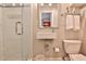 Compact bathroom featuring a glass enclosed shower, toilet and sleek, modern vanity at 4476 Paces Battle Nw, Atlanta, GA 30327