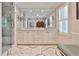Luxurious bathroom with a marble floor, double vanity, and frameless glass shower with subway tile at 4476 Paces Battle Nw, Atlanta, GA 30327
