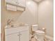 Cozy bathroom featuring a sink, toilet, and cabinet for practical storage solutions at 4476 Paces Battle Nw, Atlanta, GA 30327