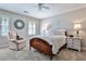 Comfortable bedroom with a ceiling fan, decorative mirror, neutral walls, and traditional furnishings at 4476 Paces Battle Nw, Atlanta, GA 30327