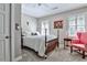 Cozy bedroom featuring a four-poster bed, shuttered windows, and comfortable seating at 4476 Paces Battle Nw, Atlanta, GA 30327