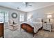 Cozy bedroom with a ceiling fan, decorative mirror, neutral walls, and traditional furnishings at 4476 Paces Battle Nw, Atlanta, GA 30327