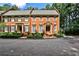 Traditional brick townhome with meticulously landscaped front yard and inviting entryway at 4476 Paces Battle Nw, Atlanta, GA 30327