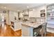 White kitchen with granite countertops, island, stainless steel appliances and hardwood floors at 4476 Paces Battle Nw, Atlanta, GA 30327