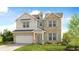 Charming two-story home with a combination of brick and siding, complemented by a landscaped yard and a two-car garage at 11 Bennett Farm Dr, Loganville, GA 30052