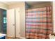 Bathroom with striped shower curtain and neutral walls at 147 Harris Loop, Dallas, GA 30157