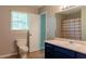 Bathroom featuring a toilet, vanity with sink, and a window for natural light at 147 Harris Loop, Dallas, GA 30157