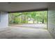View from the carport that overlooks the spacious backyard with abundant trees and nature at 147 Harris Loop, Dallas, GA 30157