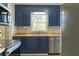 Kitchen features stainless steel appliances and dark blue cabinets at 147 Harris Loop, Dallas, GA 30157