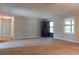 Living room features a neutral carpet and an entrance door at 147 Harris Loop, Dallas, GA 30157