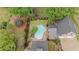 Aerial view of a private backyard featuring an in-ground pool, stone patio, trampoline, and mature trees at 18 Starlight Dr, Cartersville, GA 30121