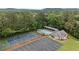 Aerial view of community amenities: tennis courts, pool, cabana, parking, and mature trees at 18 Starlight Dr, Cartersville, GA 30121