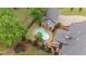 Overhead shot of a fenced backyard with a pool, cabana, lush trees, and a manicured lawn at 18 Starlight Dr, Cartersville, GA 30121