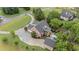 Stunning aerial view of a brick home with a circular driveway, swimming pool, and lush landscaping at 18 Starlight Dr, Cartersville, GA 30121