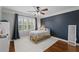 Comfortable bedroom with a feature wall, ceiling fan, and bright natural light at 18 Starlight Dr, Cartersville, GA 30121