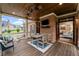 Inviting covered deck with brick wall, TV and view to interior living room at 18 Starlight Dr, Cartersville, GA 30121