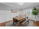 Bright dining room featuring a wood table, upholstered chairs, bench seating and hardwood floors at 18 Starlight Dr, Cartersville, GA 30121