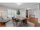An elegant dining room with a wooden table set, a cozy rug and wainscoting on the walls at 18 Starlight Dr, Cartersville, GA 30121