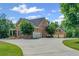 Brick home with a circular driveway leading to a three-car garage and a separate two-car garage at 18 Starlight Dr, Cartersville, GA 30121
