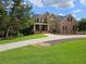 Charming two-story brick home with a manicured lawn, long driveway, and inviting front porch with swing at 18 Starlight Dr, Cartersville, GA 30121