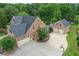 Aerial shot of a brick home, featuring a large driveway, three-car garage, and well-maintained landscaping at 18 Starlight Dr, Cartersville, GA 30121