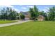 Expansive brick home featuring a large, well-manicured lawn and a circular driveway leading to multiple garage spaces at 18 Starlight Dr, Cartersville, GA 30121