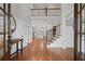 Spacious foyer with hardwood floors, staircase, and view into the modern kitchen at 18 Starlight Dr, Cartersville, GA 30121