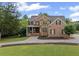 Beautiful two-story brick home with manicured lawn and stone accents on a sunny day at 18 Starlight Dr, Cartersville, GA 30121