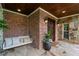 Charming covered front porch with stone accents, a swing, and a welcoming entrance at 18 Starlight Dr, Cartersville, GA 30121