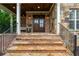 Inviting front porch with stone steps, brick accents, and a cozy seating area at 18 Starlight Dr, Cartersville, GA 30121