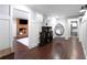 Open hallway with a brick fireplace, hanging chair, and hardwood floors leading to the kitchen at 18 Starlight Dr, Cartersville, GA 30121