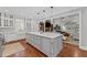 Bright kitchen with a gray island, white cabinetry, stainless steel appliances, and hardwood floors at 18 Starlight Dr, Cartersville, GA 30121