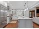 Well lit kitchen with a large island, stainless appliances, white marble countertops, and hardwood floors at 18 Starlight Dr, Cartersville, GA 30121