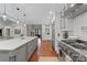 Bright kitchen featuring hardwood floors, a large island, stainless steel appliances, and marble backsplash at 18 Starlight Dr, Cartersville, GA 30121