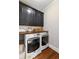 Convenient laundry room featuring a modern washer and dryer and upper cabinets at 18 Starlight Dr, Cartersville, GA 30121
