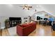 Spacious living room with a red couch, desk area with multiple monitors, and natural light at 18 Starlight Dr, Cartersville, GA 30121