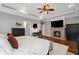 Cozy main bedroom with fireplace, tray ceiling, hardwood floors, neutral paint, and a ceiling fan at 18 Starlight Dr, Cartersville, GA 30121