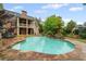 Backyard kidney shaped pool surrounded by stone with a waterfall feature in a well landscaped yard at 18 Starlight Dr, Cartersville, GA 30121