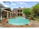 Backyard pool area featuring stone patio, waterfall feature and covered patio area at 18 Starlight Dr, Cartersville, GA 30121