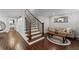 View of the staircase with hardwood floors and a cozy sitting area with a decorative light fixture at 18 Starlight Dr, Cartersville, GA 30121