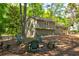 Rear exterior of the home highlighting a spacious backyard with fire pit at 944 Hardy Cir, Dallas, GA 30157