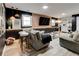 Basement living room area with a large TV, barstools, and comfortable seating at 944 Hardy Cir, Dallas, GA 30157