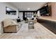 Basement living room area with a large TV, accent wall, and comfortable seating at 944 Hardy Cir, Dallas, GA 30157