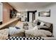 Basement living room area with a large TV, barstools, comfortable seating, and bar cabinet at 944 Hardy Cir, Dallas, GA 30157