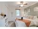 Cozy bedroom featuring a ceiling fan, natural light from the window, and a stylishly decorated bed at 944 Hardy Cir, Dallas, GA 30157