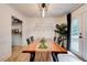 Well-lit dining room featuring a large wooden table, black chairs, and access to the backyard at 944 Hardy Cir, Dallas, GA 30157